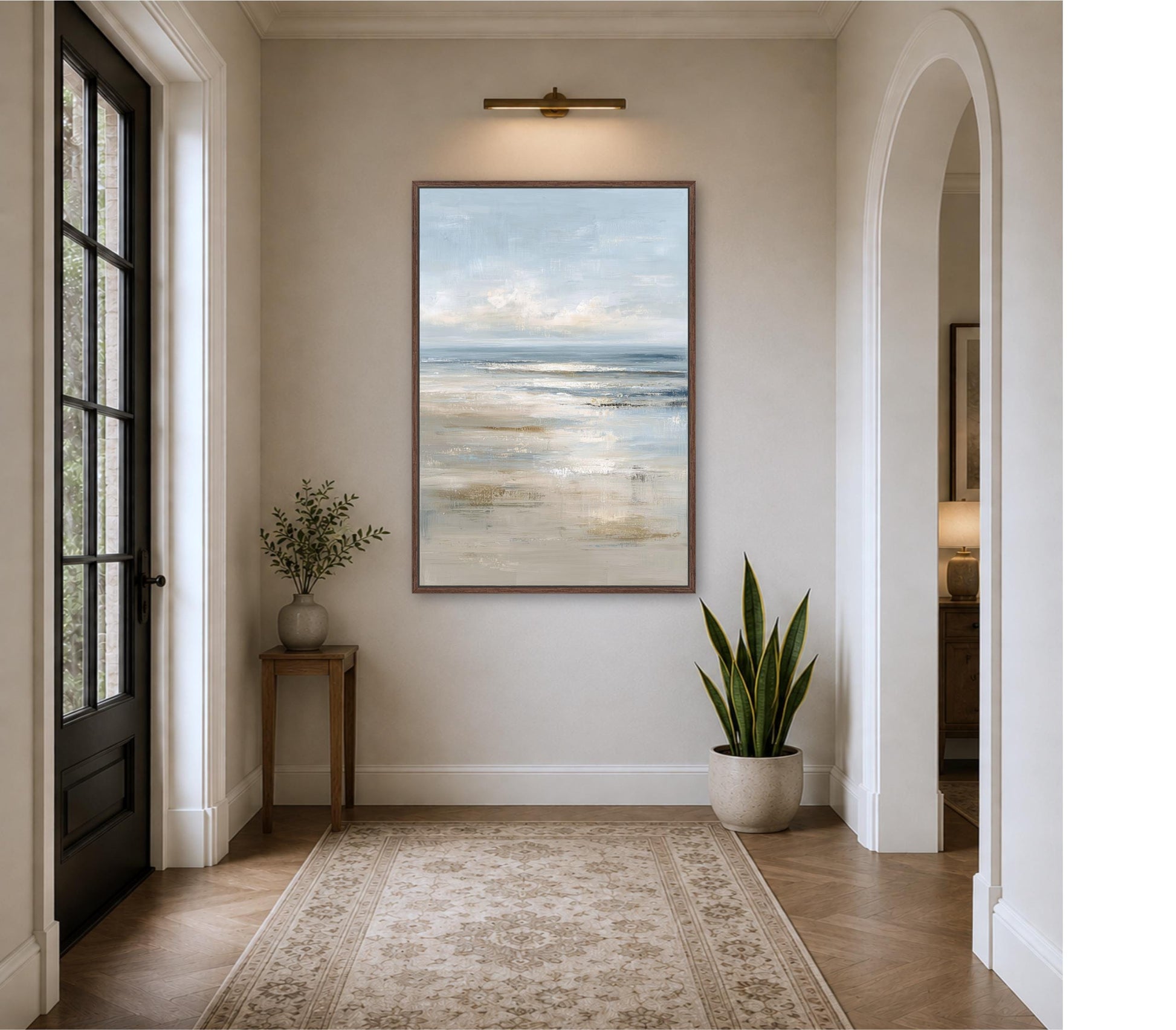 a serene and elegant hallway with a large painting of a beach scene hanging on the wall, a small table with a plant, and a rug on the floor. Abstract Ocean Framed Canvas Portrait Art, Coastal Seascape Muted Light Blue Beige, Modern Beach Landscape Artwork, Cottage Beach Print