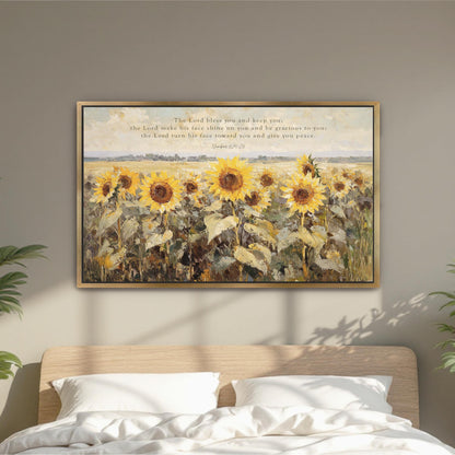 The image is a framed painting of a field of sunflowers hanging on a wall above a bed.