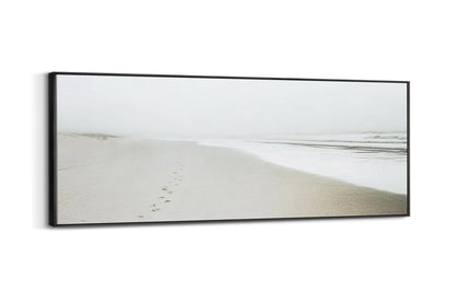 a picture of a beach with footprints in the sand