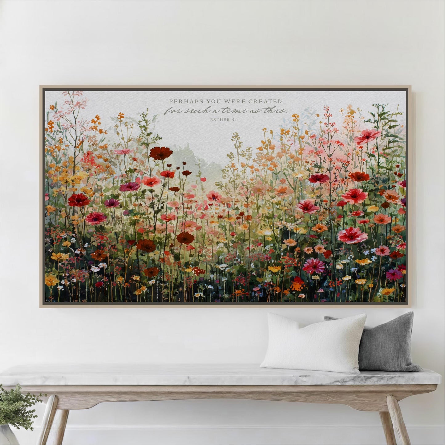 a large, colorful painting of a field of flowers hanging on a wall above a wooden bench.