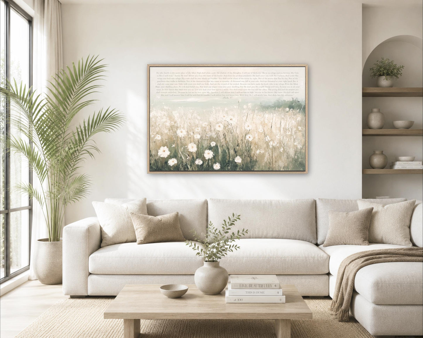 a cozy living room with a large white sofa, a wooden coffee table, and a framed painting of a field of flowers hanging on the wall.