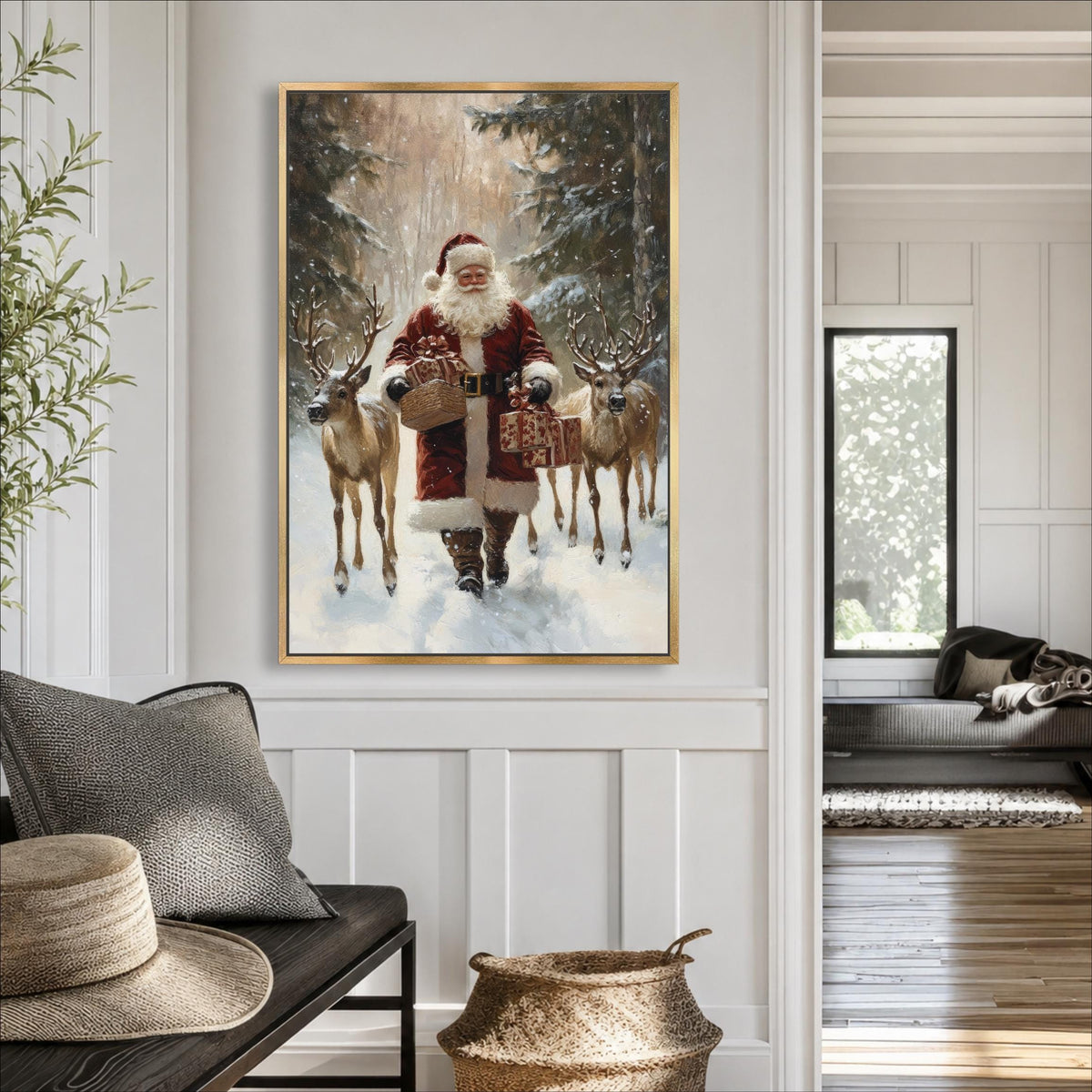 A framed painting of Santa Claus holding reindeer in a snowy forest setting hangs on a wall in a cozy living room.