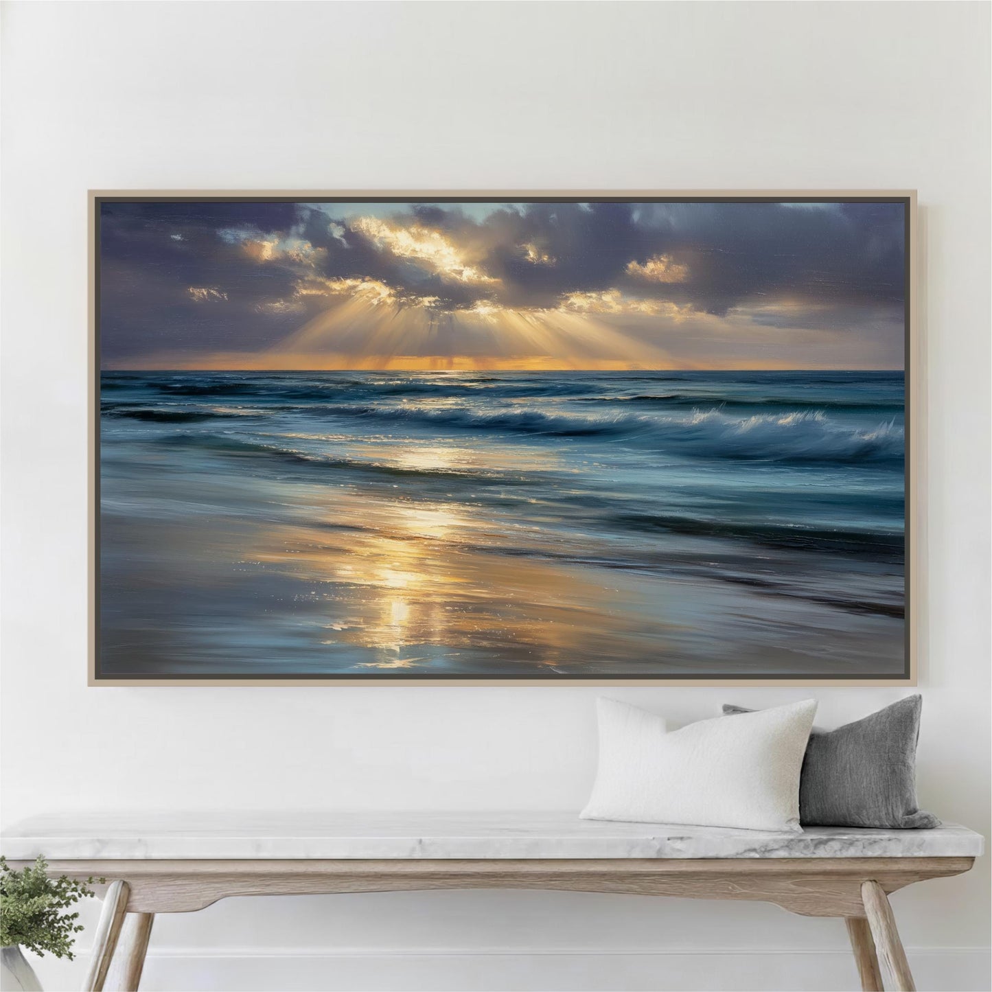 A large framed painting depicting a serene beach scene with waves crashing against the shore, and the sun's rays shining through the clouds, creating a beautiful reflection on the water.