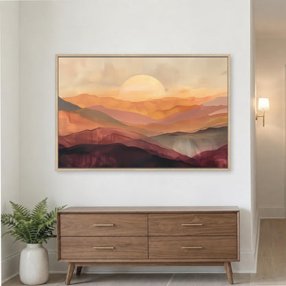a large, framed painting of a sunset over mountains hanging on a wall above a wooden dresser.