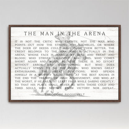 a quote by Theodore Roosevelt, a famous American president, which is framed and displayed in a wooden frame.