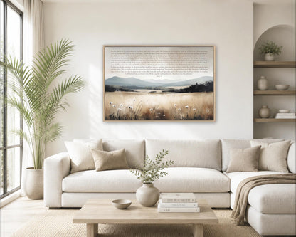 a cozy living room with a large white sofa, a wooden coffee table, and a framed landscape painting hanging on the wall above the sofa.