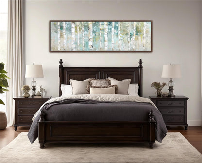 a serene and cozy bedroom with a large bed, dark wood furniture, and a framed artwork featuring a forest scene on the wall above it.