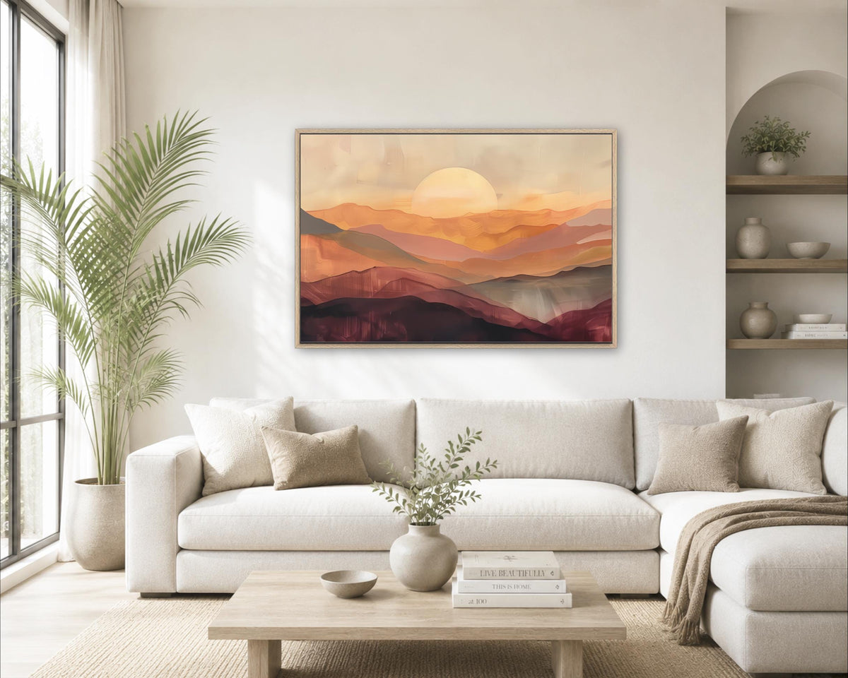a cozy living room with a large, framed painting of a sunset over mountains hanging on the wall. The room is decorated with a white sofa, a coffee table, and various plants, creating a warm and inviting atmosphere.