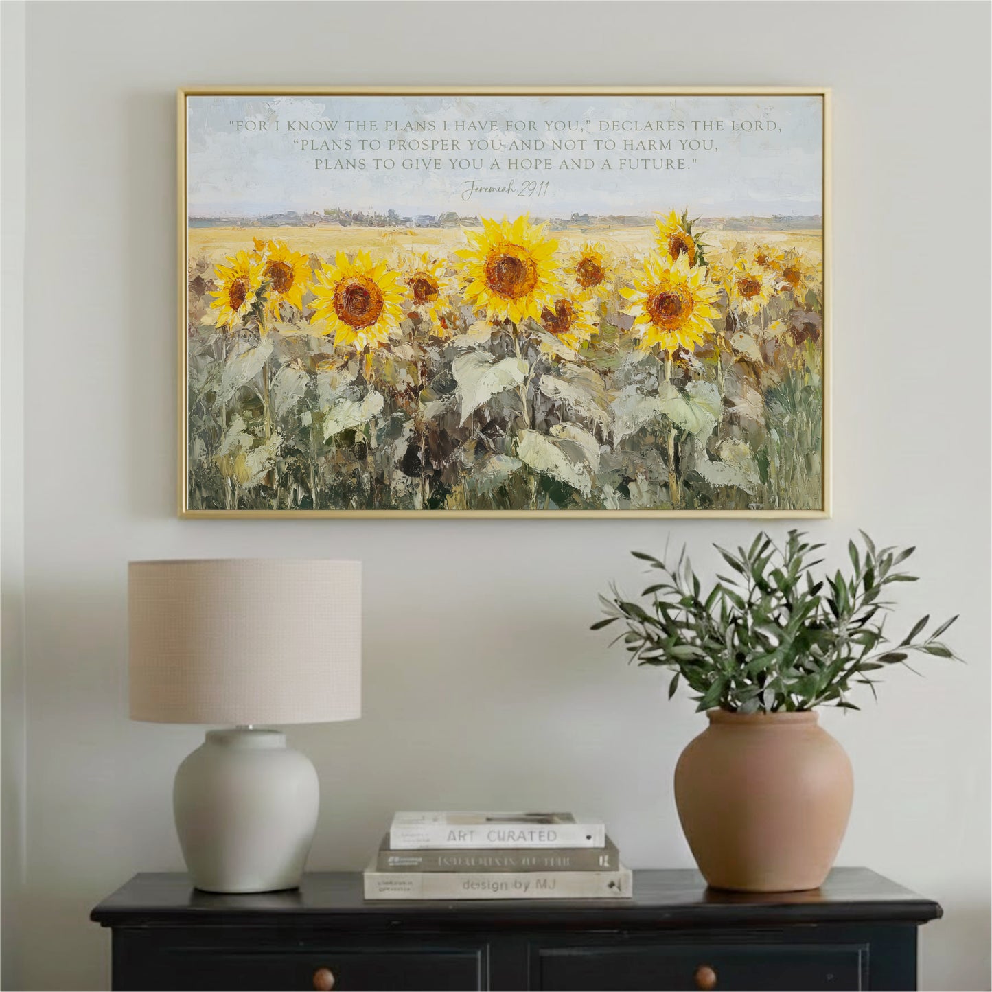 a framed painting of a field of vibrant yellow sunflowers, with a lamp and a potted plant on a table below it.