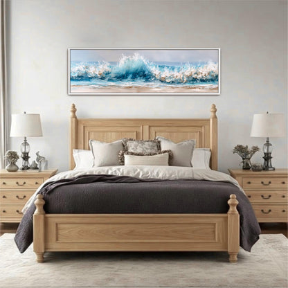 a large wooden bed with a gray comforter and pillows, positioned in front of a large window. Above the bed, there is a framed painting depicting a crashing wave. The room has a neutral color scheme with white walls and a gray carpet.