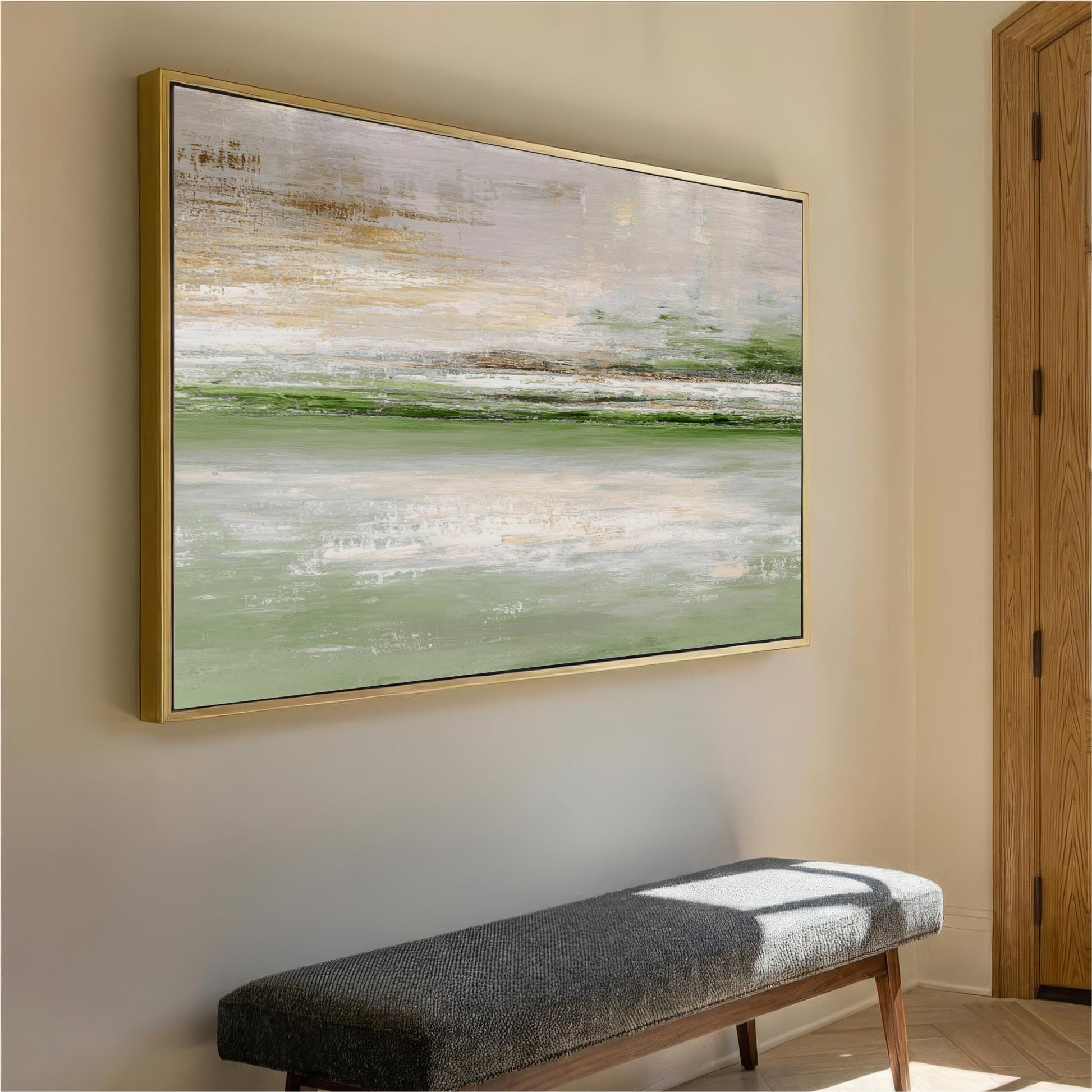 a large, abstract painting hanging on a wall above a gray bench in a hallway.