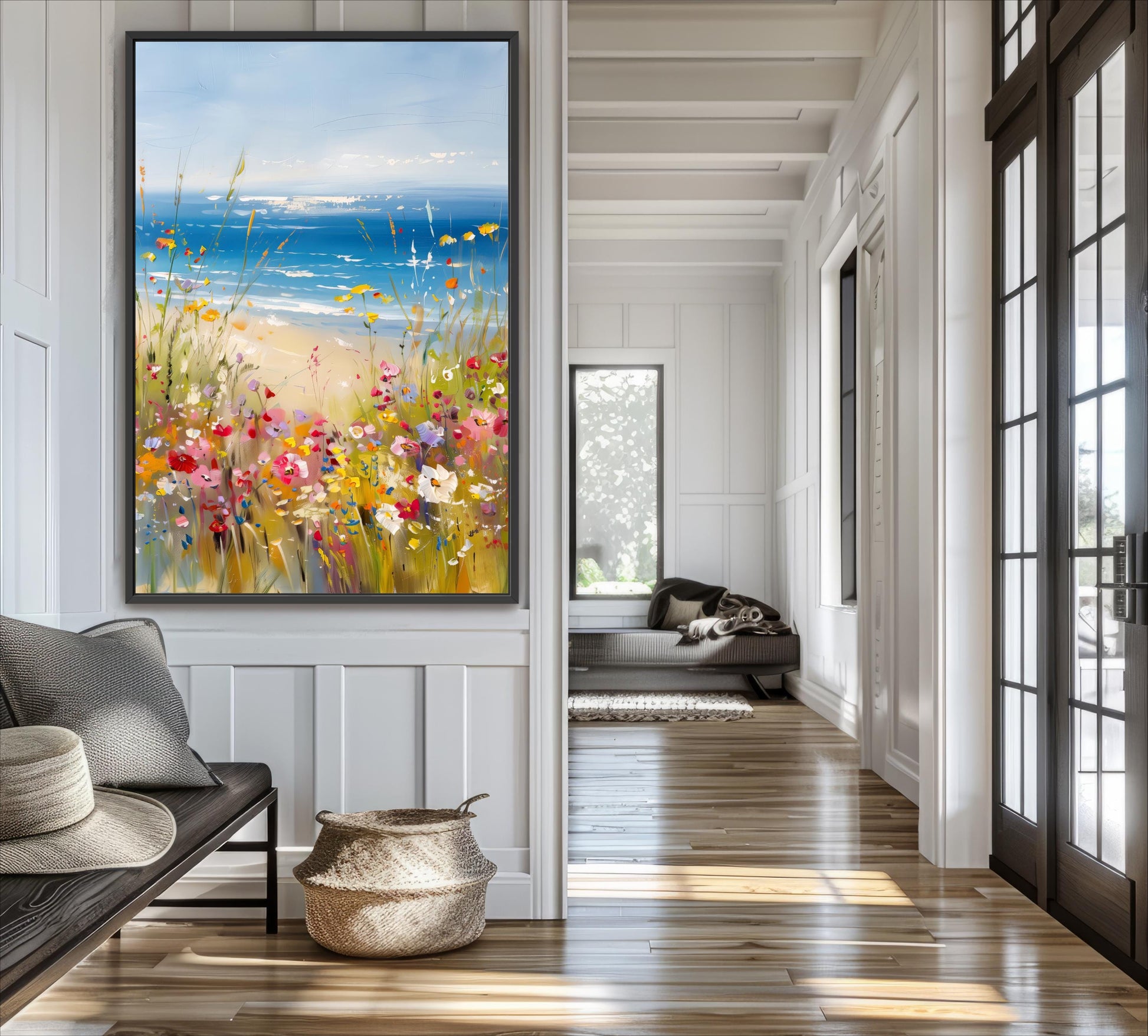 a large painting of a beach scene with a blue sky, ocean, and colorful flowers hanging on the wall of a bright and airy room with wooden floors and white walls.