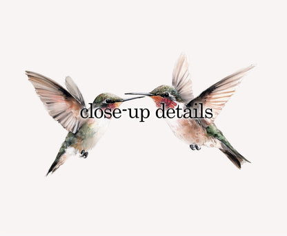 two hummingbirds in flight, with their wings spread wide.