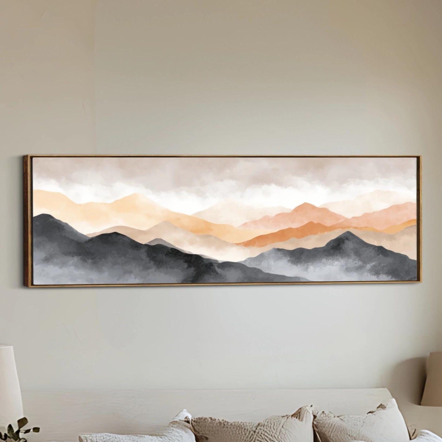 a large, framed painting of a mountain landscape hanging on a wall.