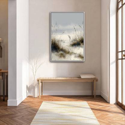 a serene indoor setting with a large painting of a beach scene hanging on the wall, featuring a bird standing on the sand. The painting is framed in a white frame and is the focal point of the room. In front of the painting, there is a wooden bench, and a small tree is visible on the left side of the image. The room has a wooden floor and white walls, creating a calm and peaceful atmosphere.