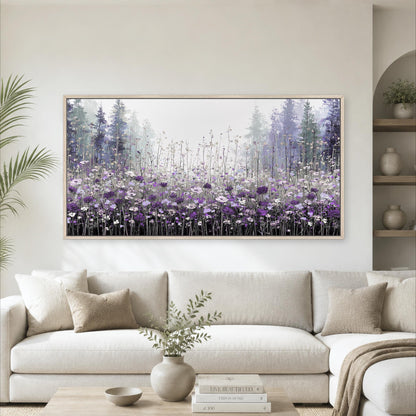 a large framed painting of a field of purple flowers hanging on a wall above a white sofa in a living room.