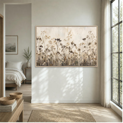 a large, framed painting of a field of flowers hanging on a wall in a bedroom.