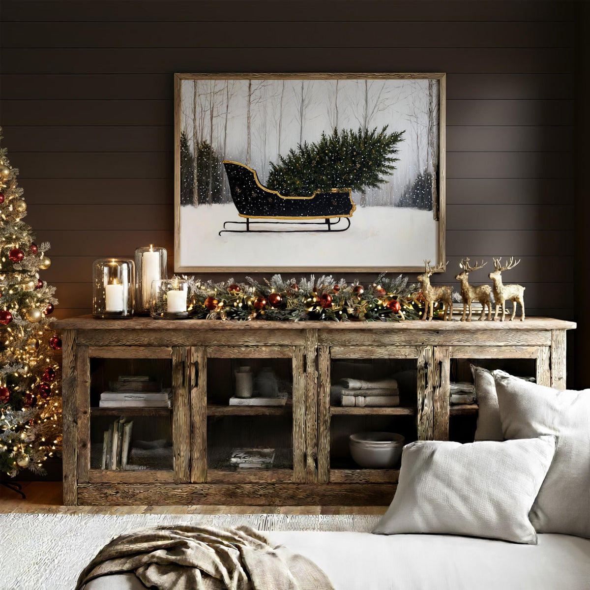 a cozy living room decorated for Christmas, with a large framed picture of a Christmas tree on the wall above a wooden entertainment center. The entertainment center has glass doors and shelves, and there are several books and decorative items displayed on it. In the foreground, there is a couch with pillows, and a Christmas tree can be seen in the background.
