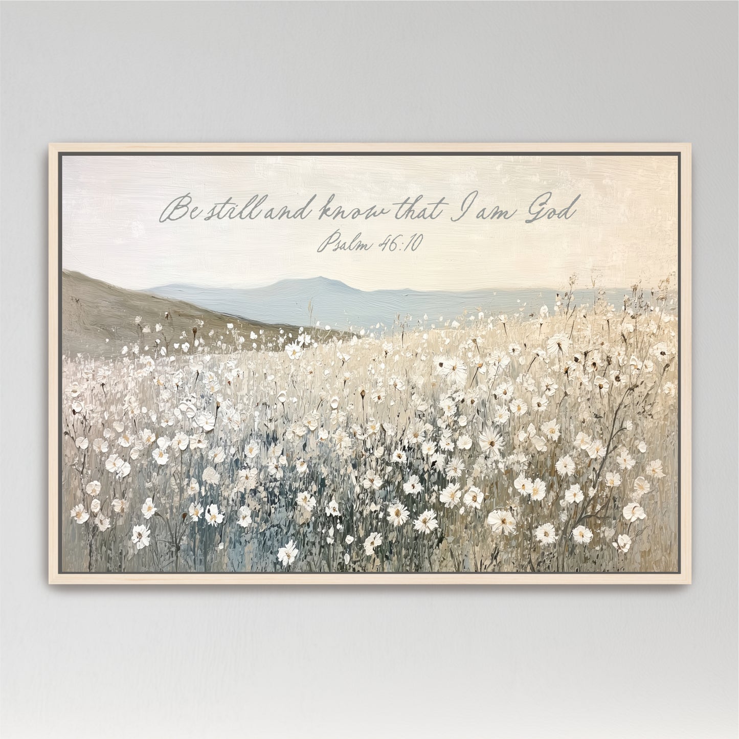 The image is a painting of a field of white flowers, with mountains in the background. The painting is framed and has a Bible verse from Psalm 46:10 overlaid on it.