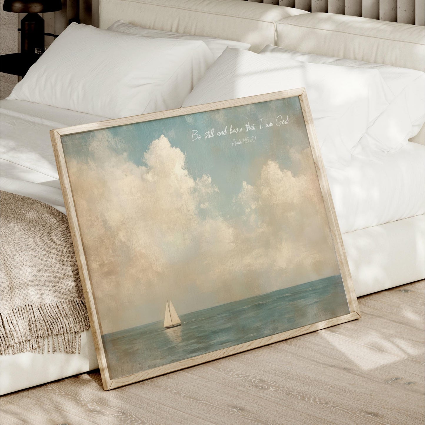 a framed painting of a sailboat on the ocean, with a serene and peaceful atmosphere.