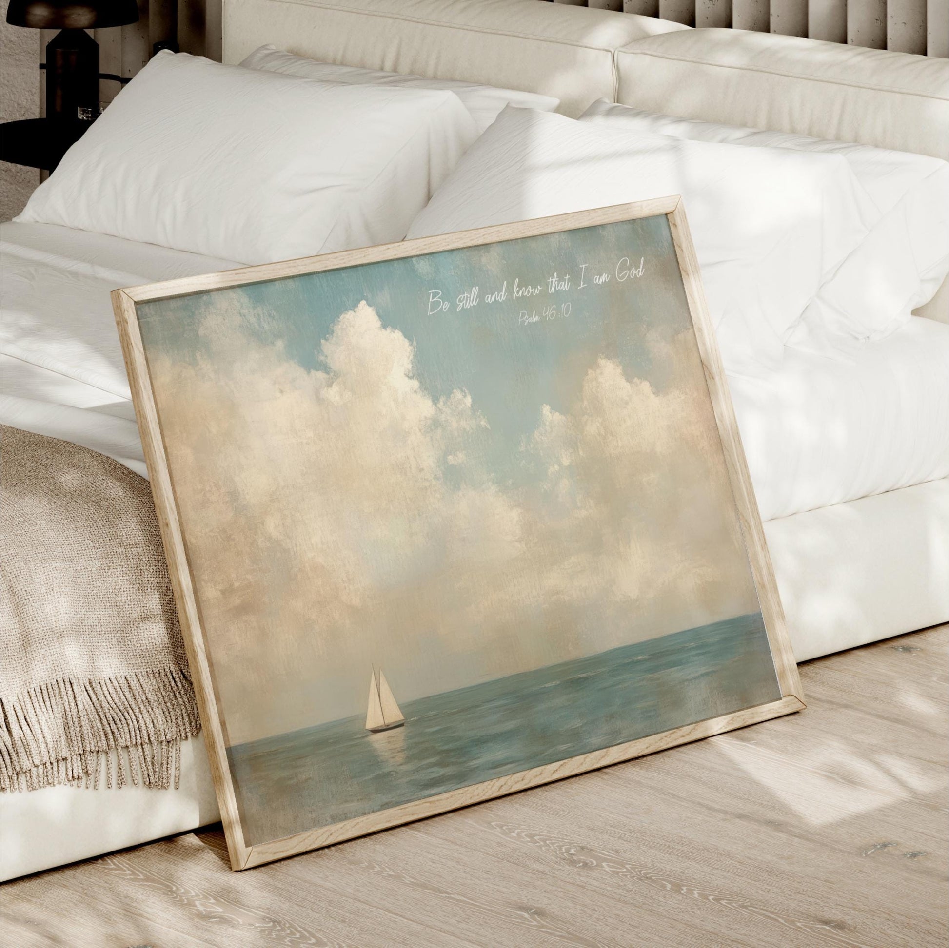 a framed painting of a sailboat on the ocean, with a serene and peaceful atmosphere.