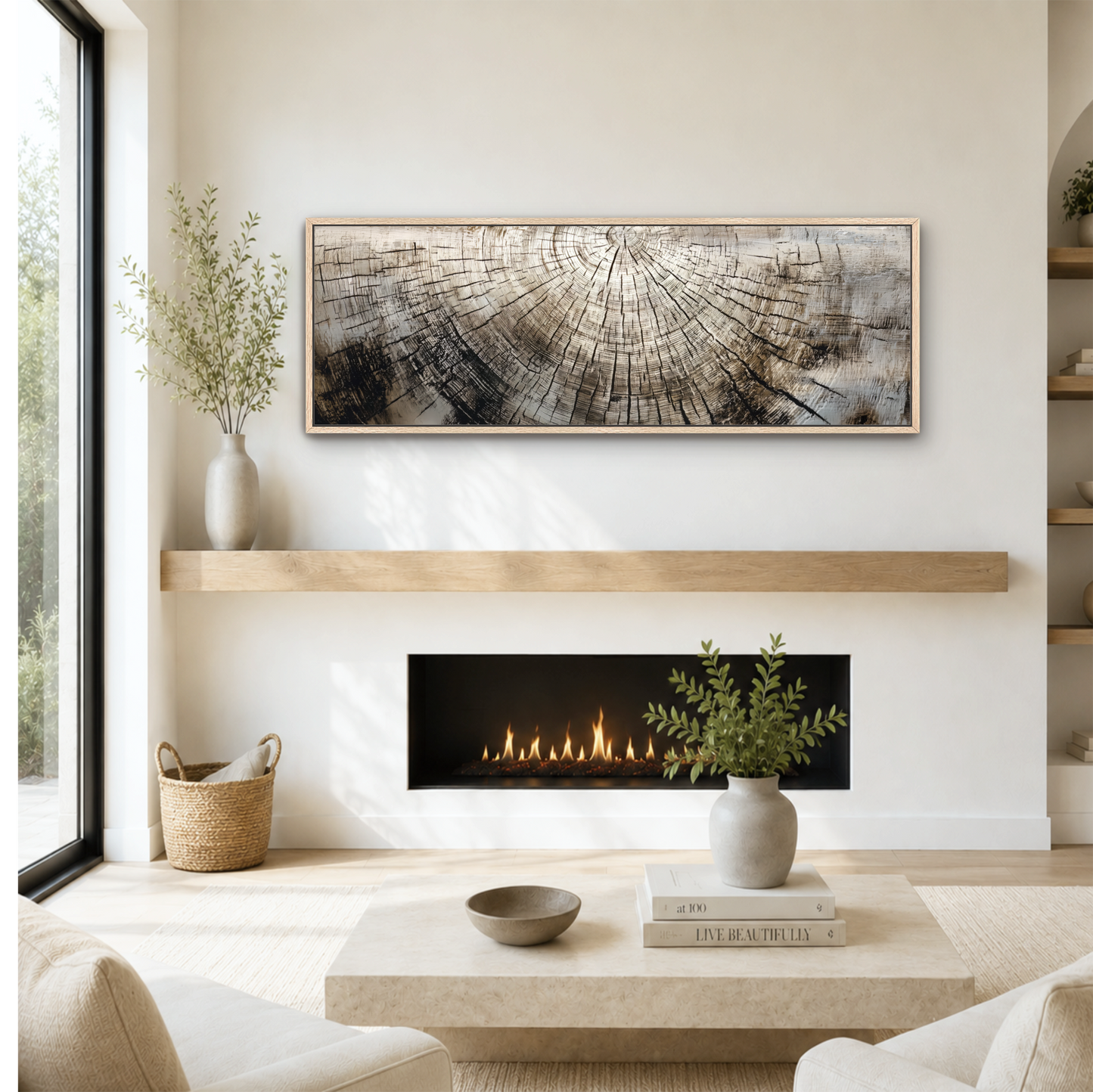 a cozy living room with a fireplace, a coffee table, and a large painting on the wall above it. The room has a minimalist and modern design, with a neutral color palette and natural elements like plants and a woven basket.