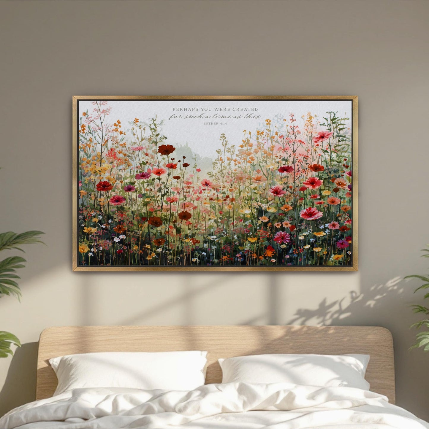 a large, colorful painting of a field of flowers hanging on a wall above a bed.