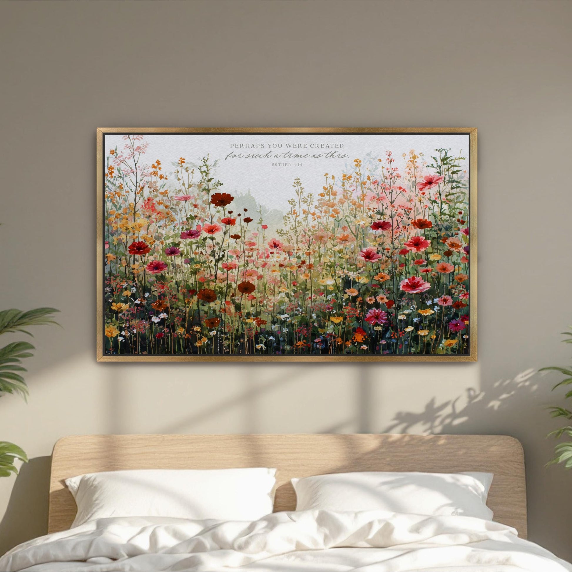 a large, colorful painting of a field of flowers hanging on a wall above a bed.