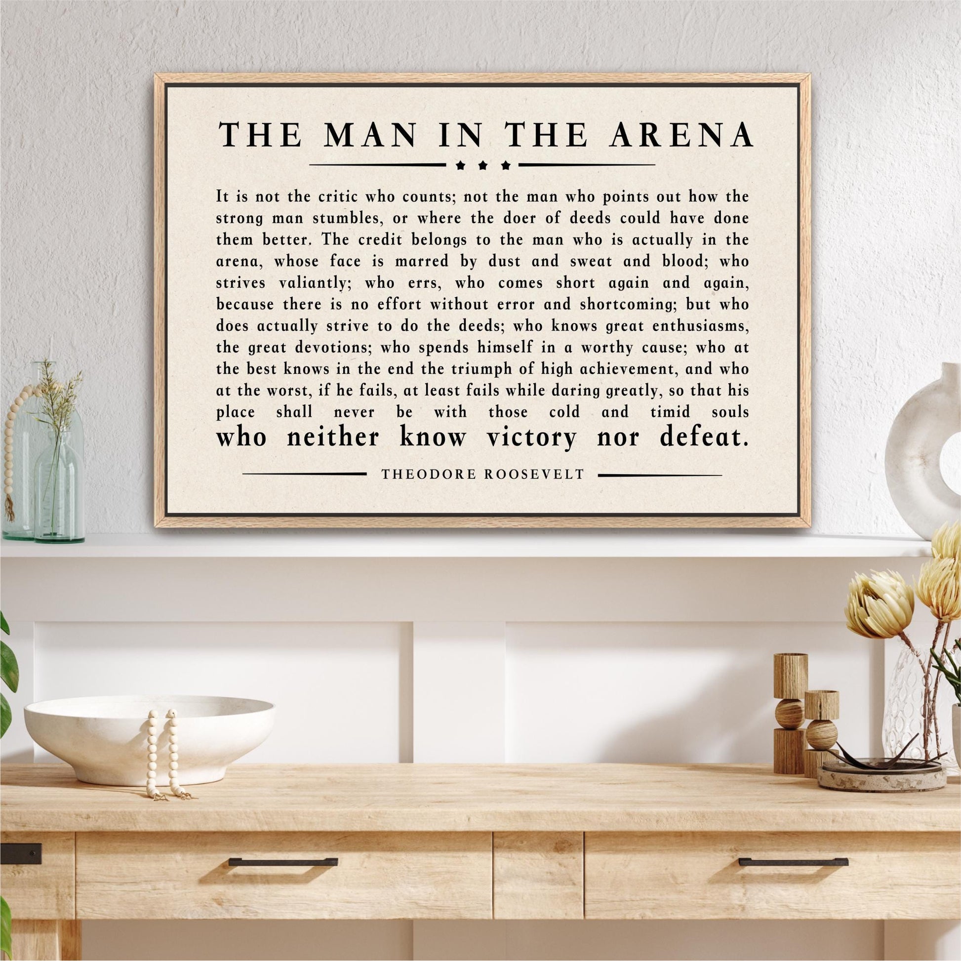 a framed quote by Theodore Roosevelt, which is a powerful piece of literature that discusses the importance of perseverance and determination in the face of challenges and adversity.