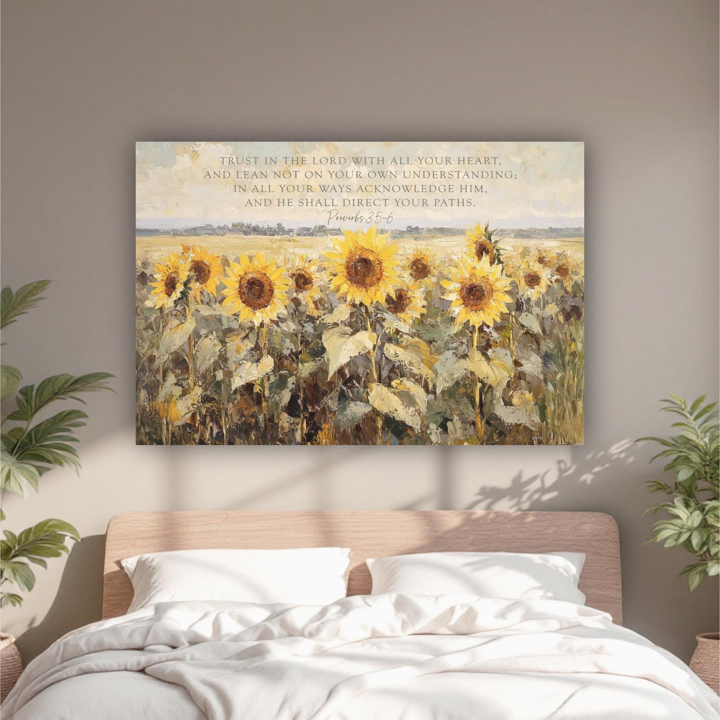 a bed with a white comforter and a painting of sunflowers