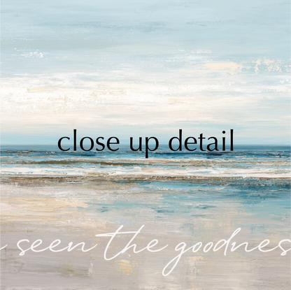 a serene beach scene with a calm ocean and a light blue sky.