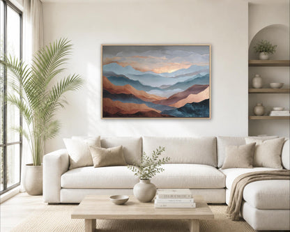 a cozy living room with a large, framed painting of mountains hanging on the wall above a white sofa. The room is decorated with a potted plant, a vase with greenery, and a stack of books on a coffee table.