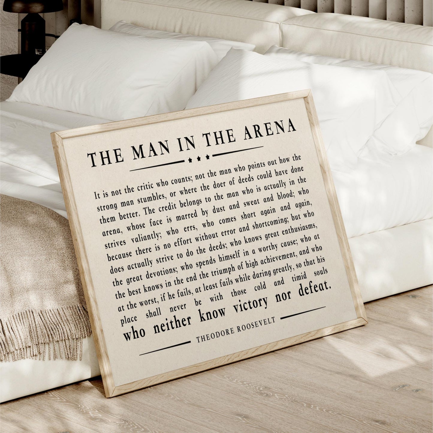 a framed quote by Theodore Roosevelt, which is a famous speech by the former US President. The quote discusses the importance of not being a critic who points out the flaws of others, but rather focusing on one's own character and actions.