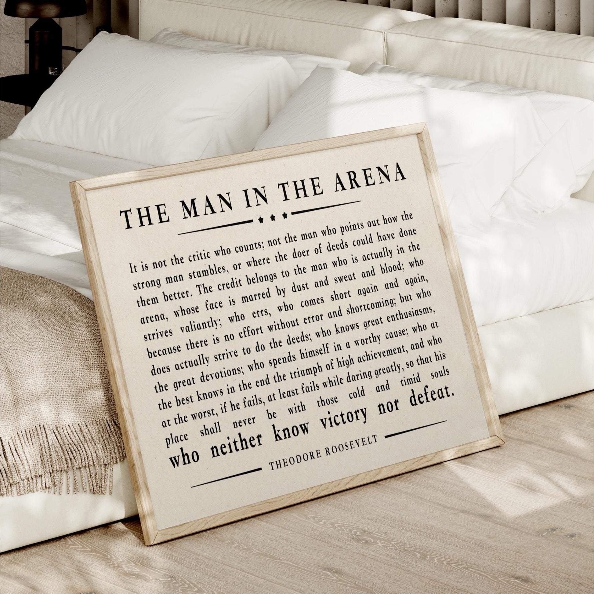 a framed quote by Theodore Roosevelt, which is a famous speech by the former US President. The quote discusses the importance of not being a critic who points out the flaws of others, but rather focusing on one's own character and actions.
