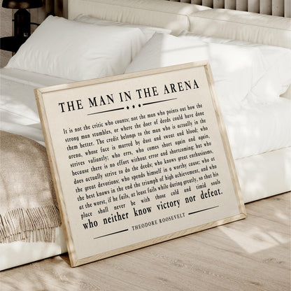 a framed quote by Theodore Roosevelt, which is a famous speech by the former US President. The quote discusses the importance of not being a critic who points out the flaws of others, but rather focusing on one's own character and actions.