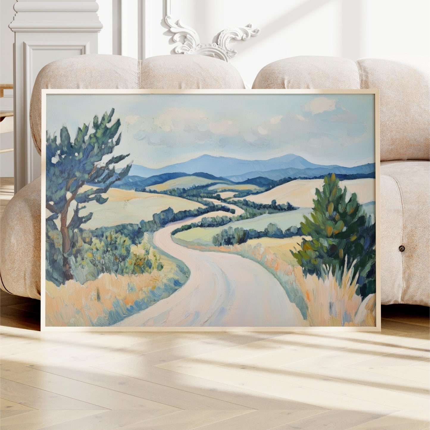 a large landscape painting depicting a winding road surrounded by rolling hills and trees.