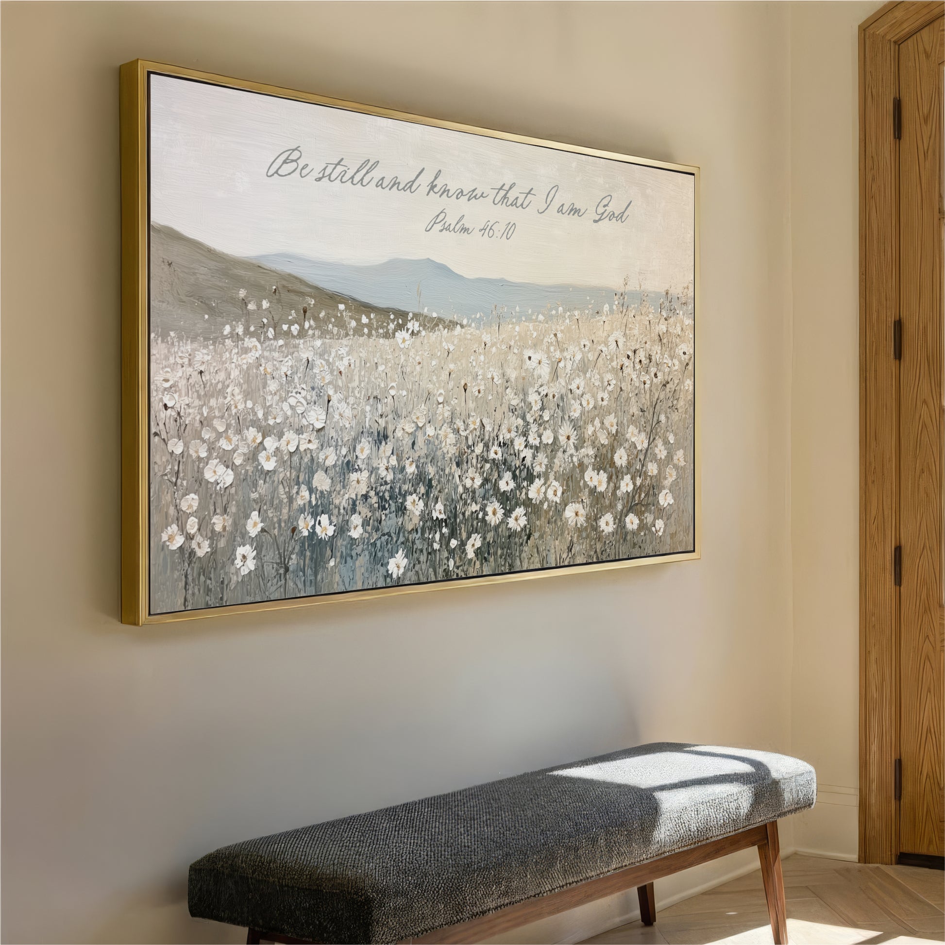 a large framed painting of a field of flowers hanging on a wall, with a bench below it.