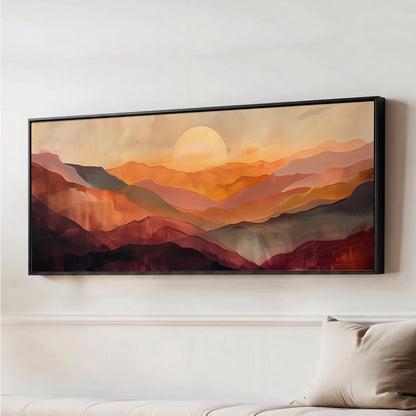 a large, framed painting of a mountainous landscape with a warm, sunset-like sky.