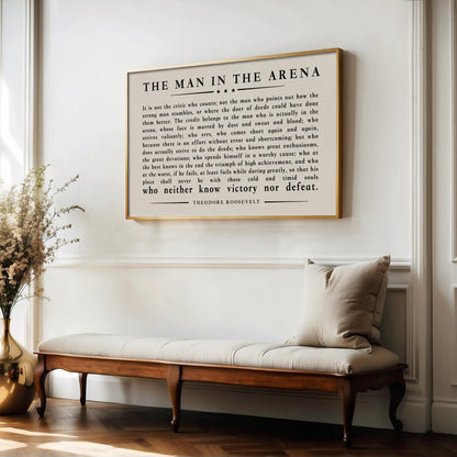 a framed quote on a wall, with a wooden bench below it.