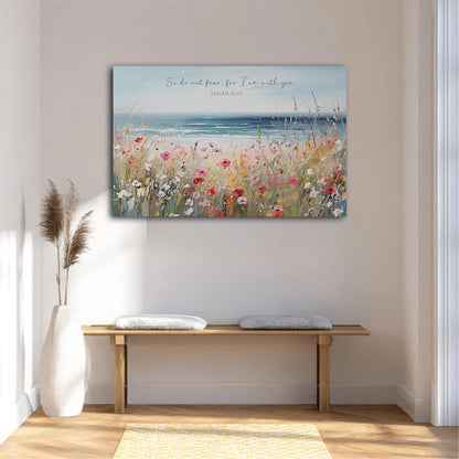 a serene indoor setting with a wooden bench, a white vase, and a potted plant. Above the bench, there is a large painting depicting a field of flowers and a body of water, with the text "So do not fear, I am with you" written above it.