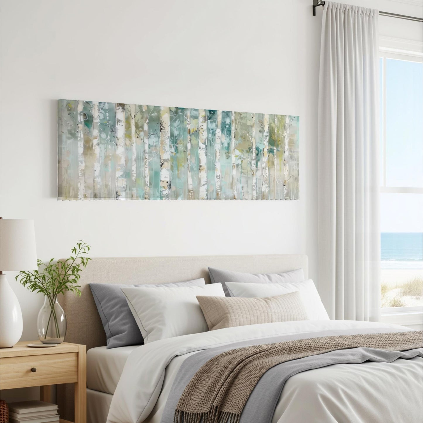 a serene bedroom scene with a large painting of trees hanging on the wall above a bed with white bedding and a gray throw blanket.