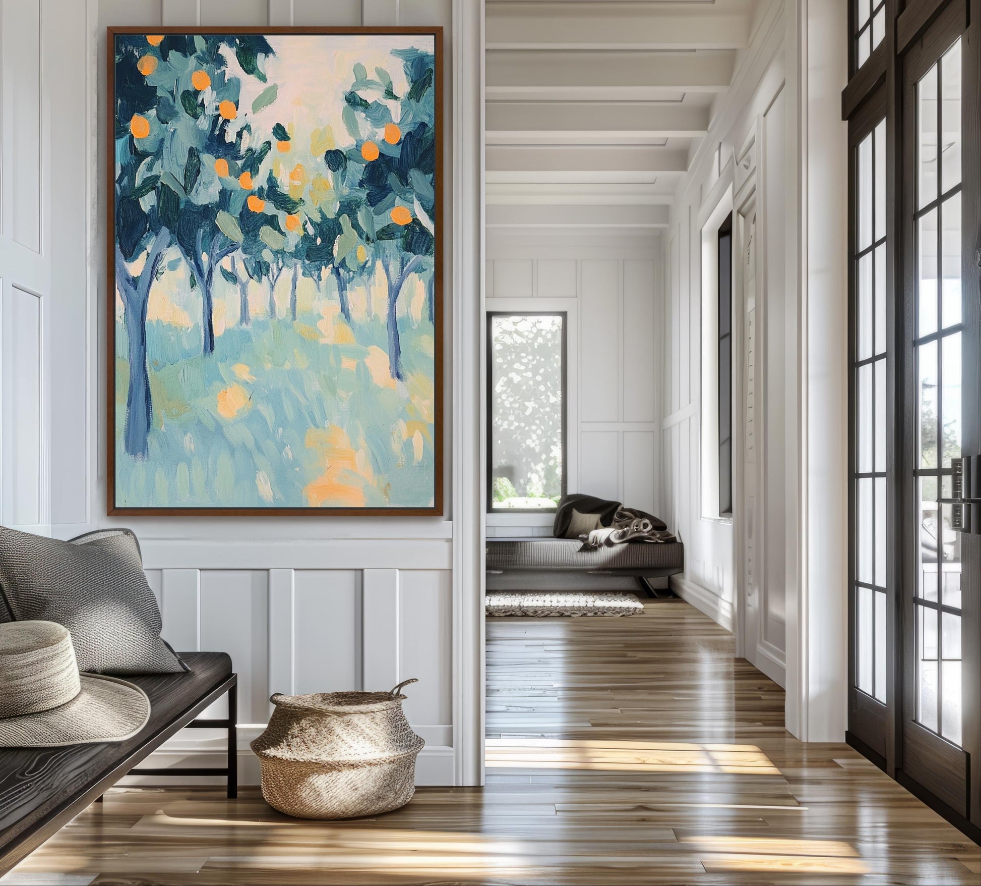 a large painting of a tree-filled landscape hanging on a wall, with a wooden floor and a window in the background.