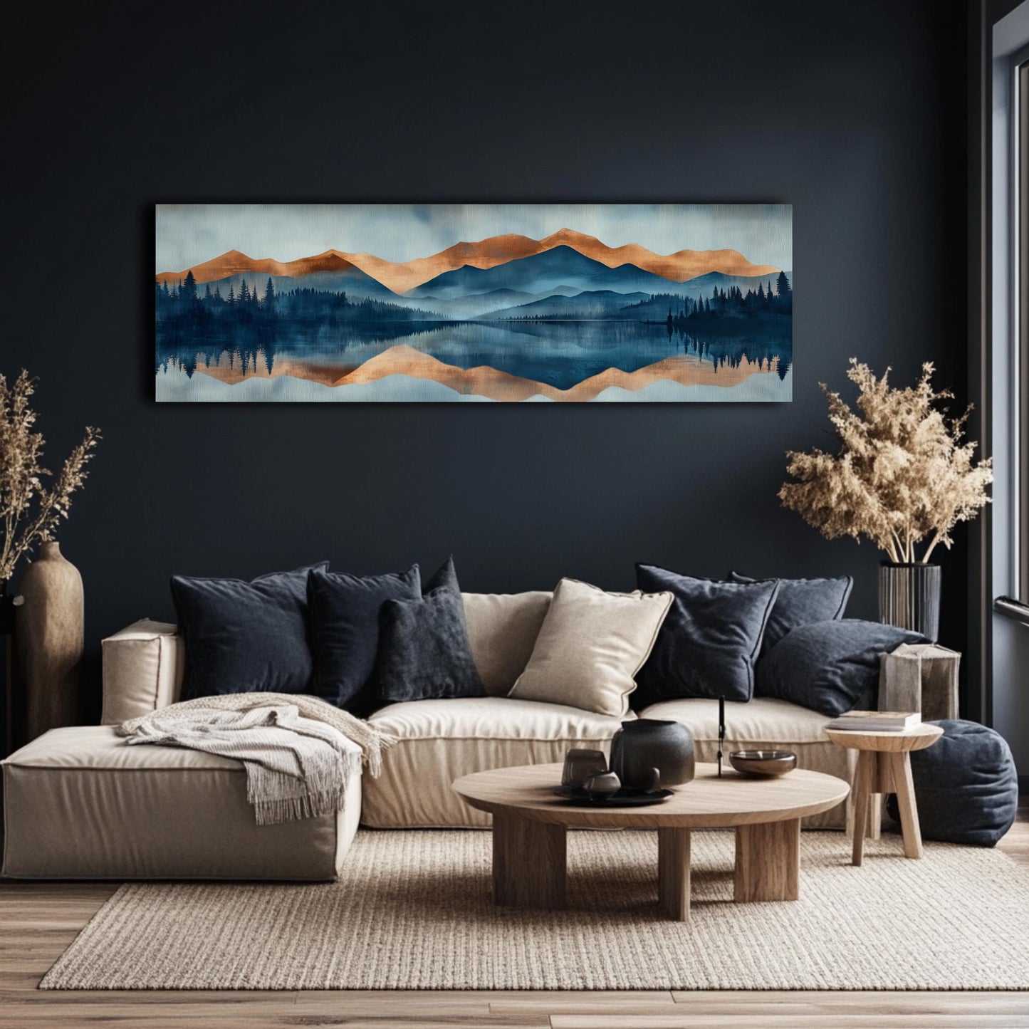 a living room with a large painting of a mountain landscape hanging on the wall above a beige sofa with blue throw pillows. The sofa is positioned in front of a wooden coffee table, and there are two potted plants on either side of the sofa. The room has a dark color scheme, with a large window providing natural light.