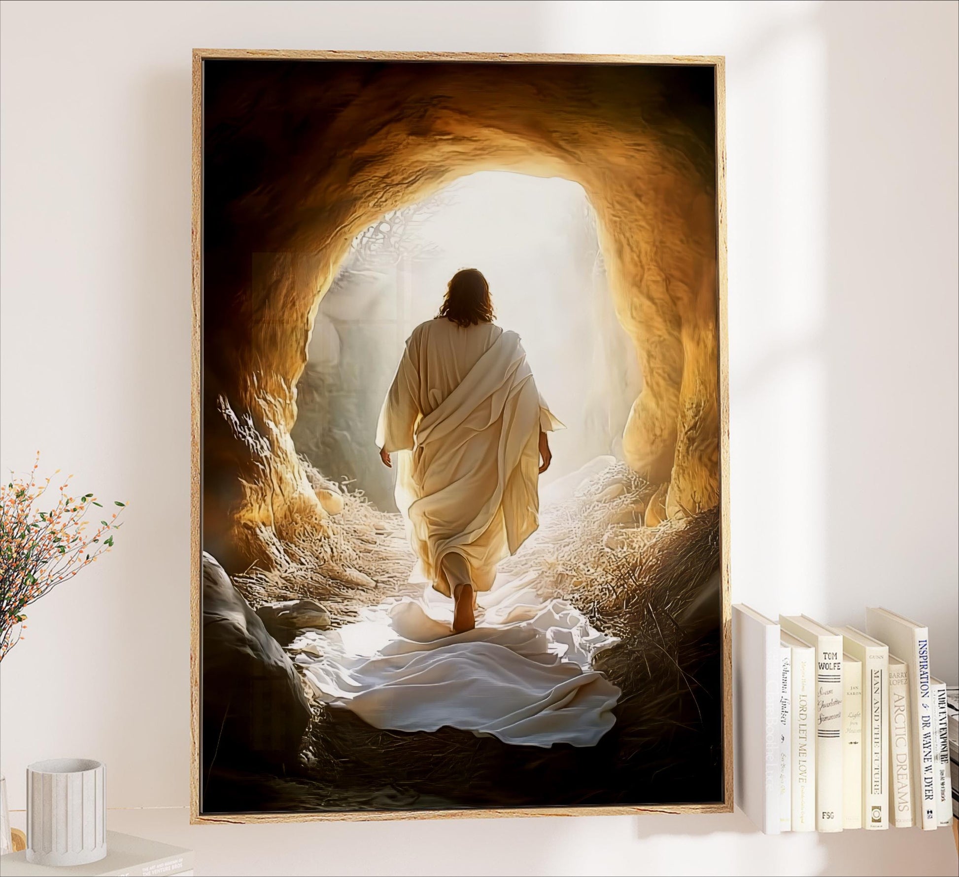 a person in a white robe walking through a cave with sunlight streaming in from the opening, creating a serene and peaceful atmosphere.
