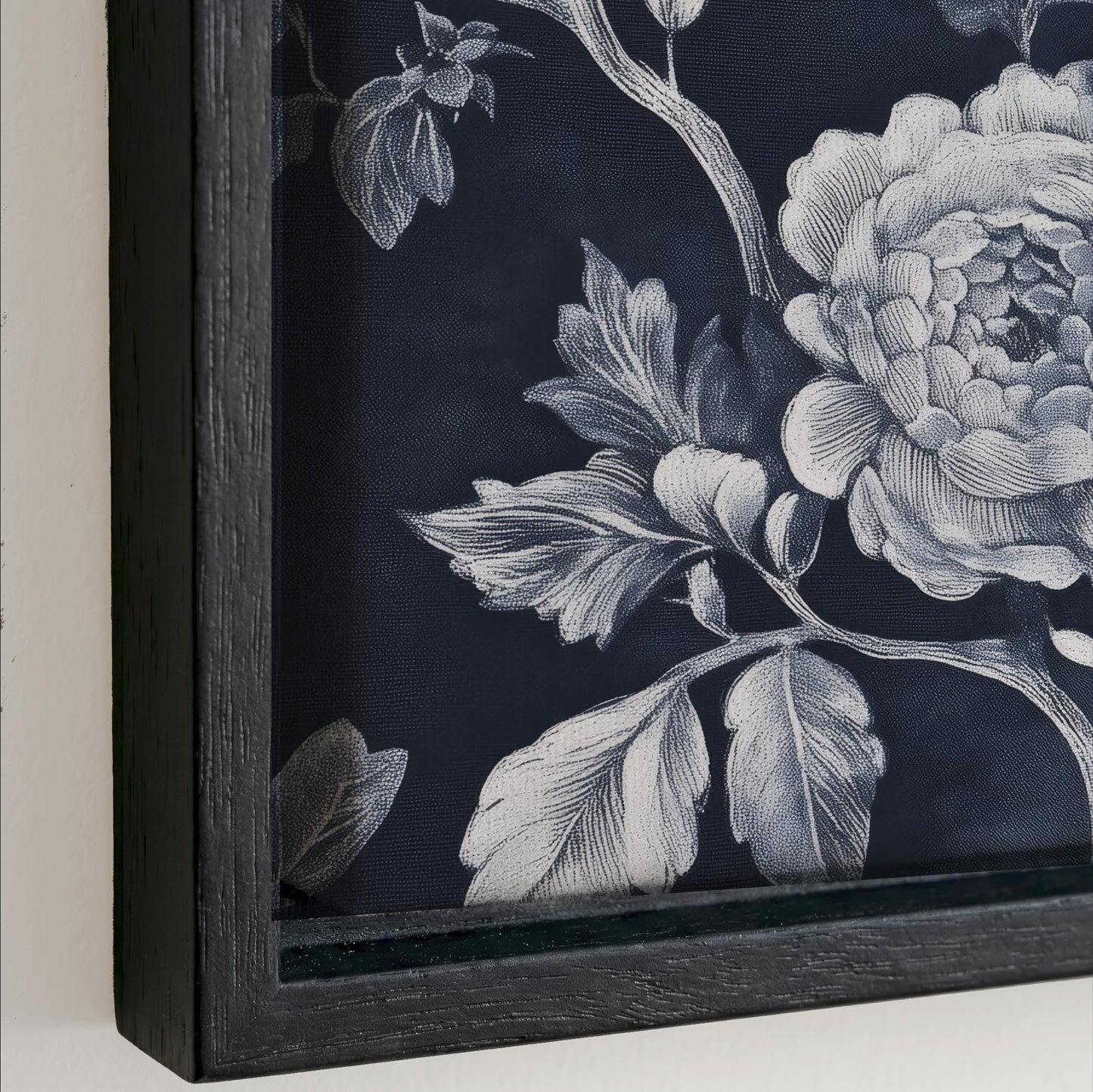 a close-up view of a black and white floral pattern on a dark background.