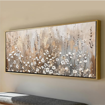 a large, framed painting of a field of white flowers on a wall.