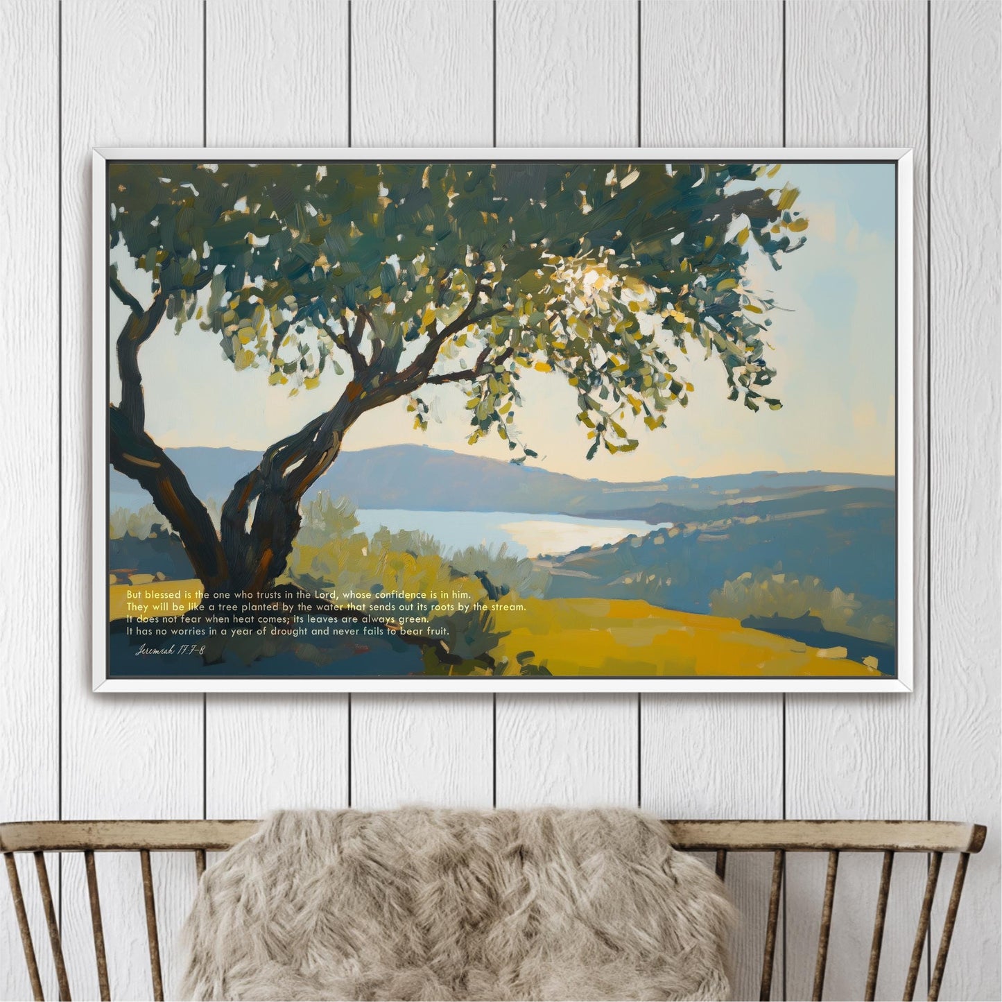 The image is a framed painting depicting a serene landscape with a large tree in the foreground and a body of water in the background. The painting is set against a white wall, and there is a wooden bench in the foreground. The painting is titled "The image depicts a tree in the foreground, with a body of water in the background."