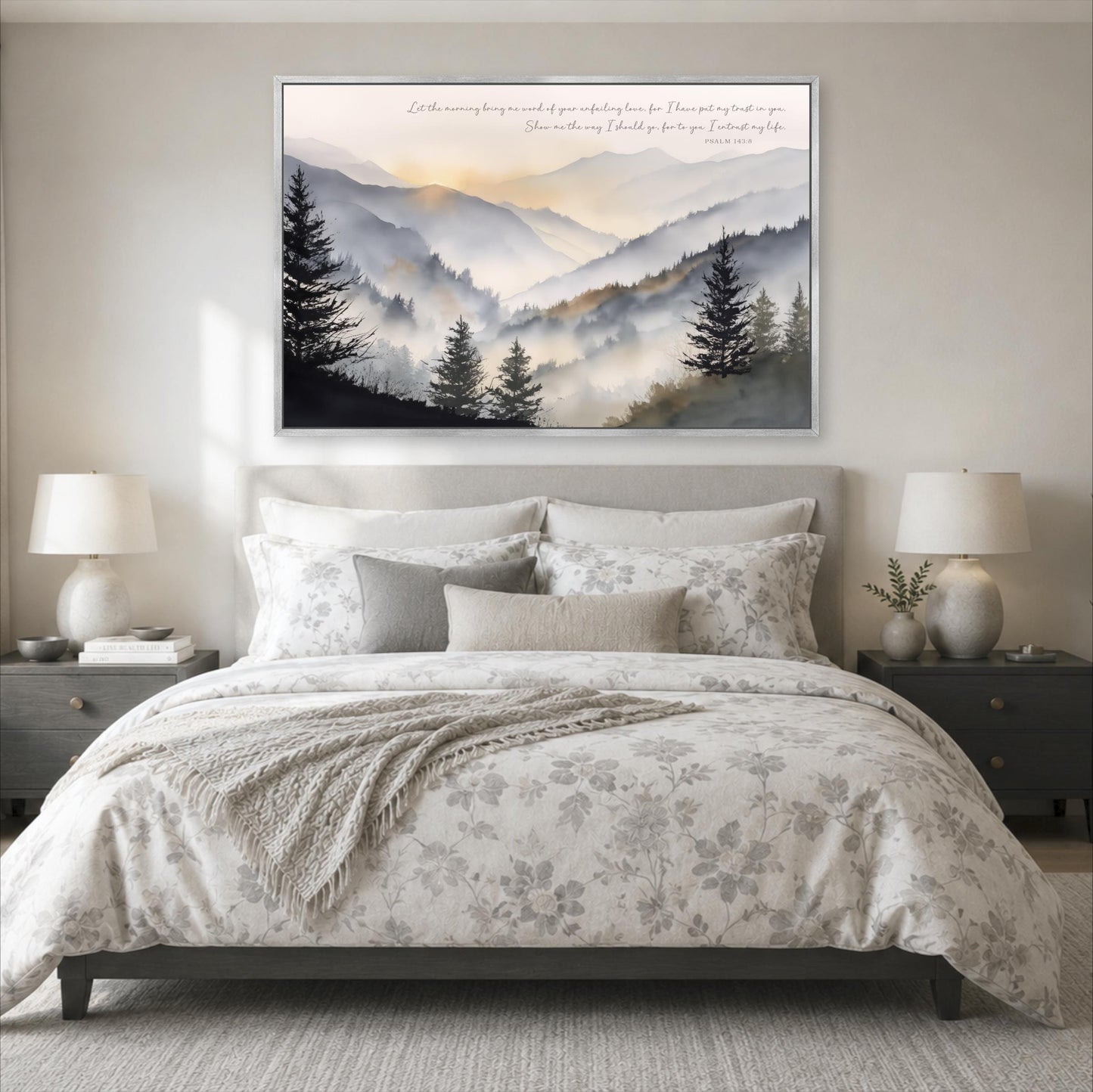 a serene bedroom scene with a large bed, a nightstand on each side, and a framed landscape painting above the bed. The painting depicts a mountain landscape with trees and a hazy, golden sky.
