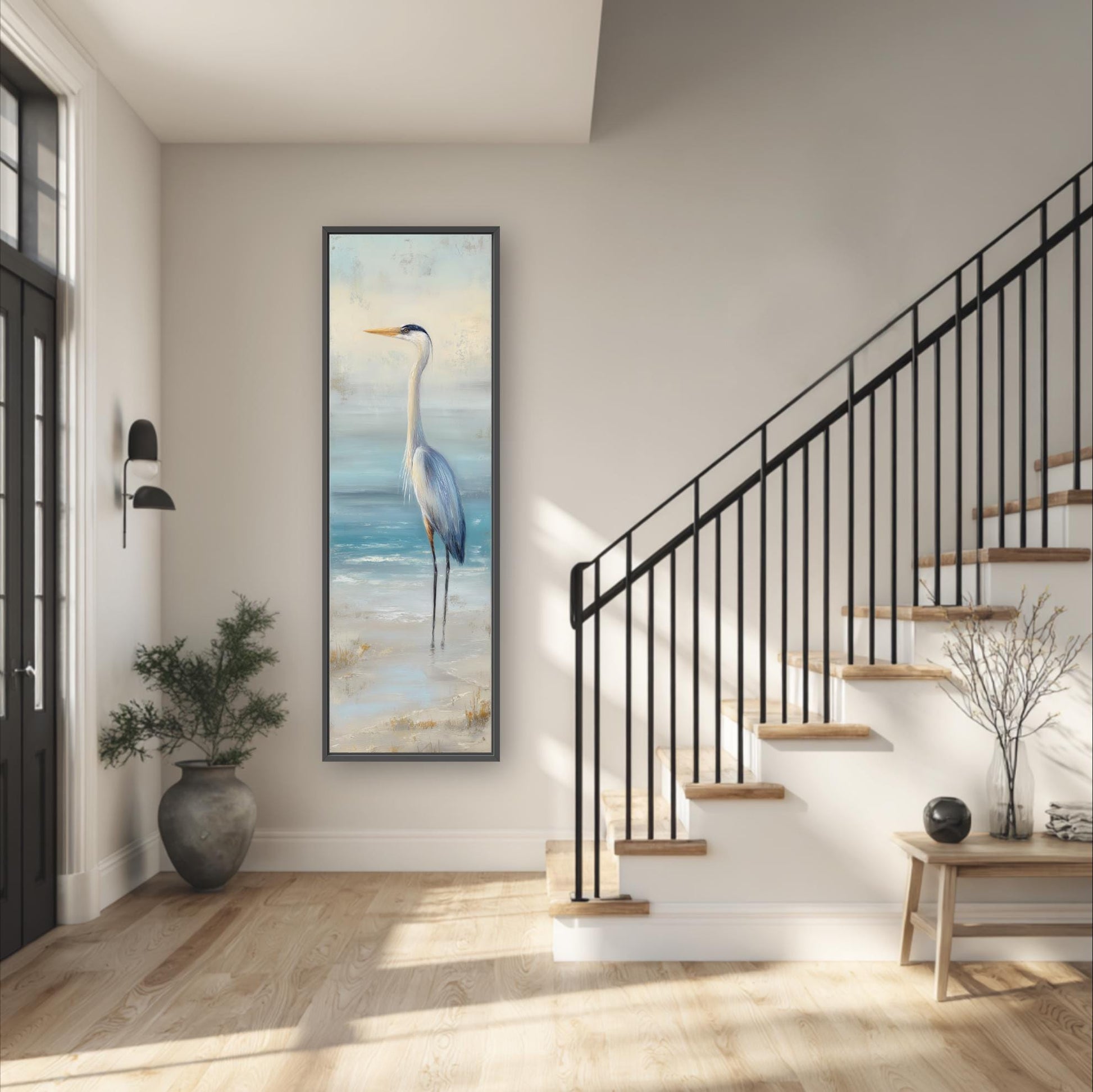 a serene indoor setting with a large painting of a bird standing on a beach, a black railing, a wooden staircase, and a potted plant.