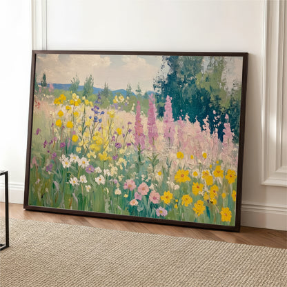 A large framed painting depicting a vibrant field of colorful flowers, including yellow, pink, and white blooms, set against a backdrop of trees and a blue sky.